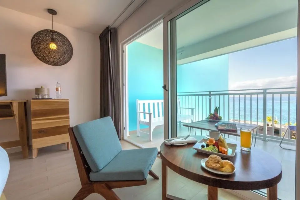Deluxe ocean view room sitting area and balcony at Fiesta Americana Cozumel.