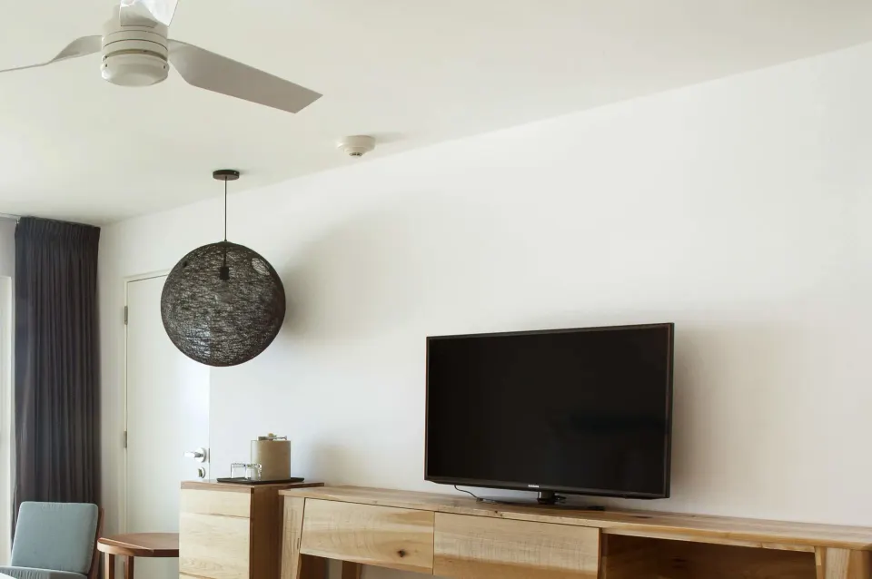 Deluxe ocean view room TV wall and wood console at Fiesta Americana Cozumel.
