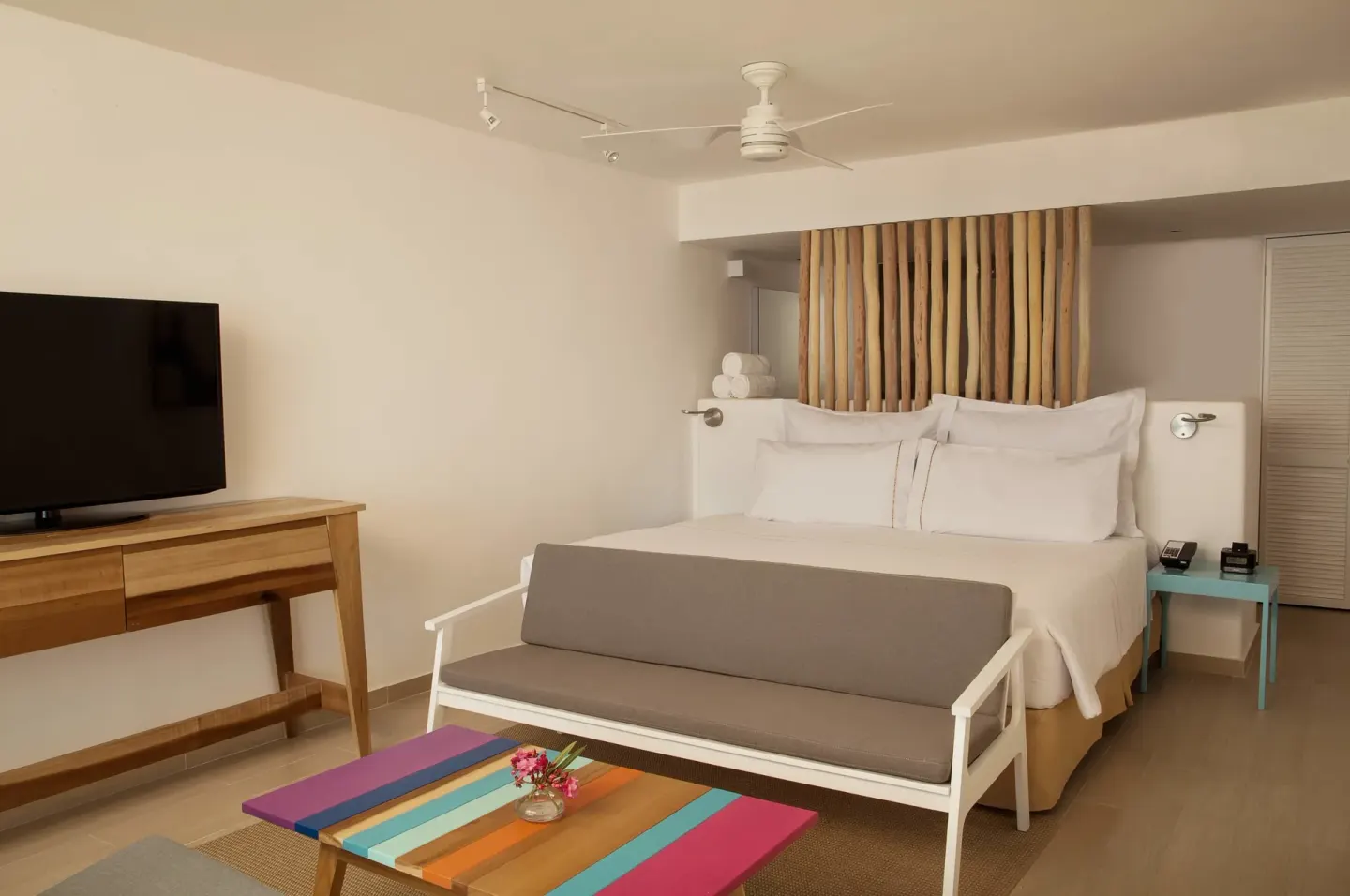 Deluxe ocean view room with king bed and sitting area at Fiesta Americana Cozumel.