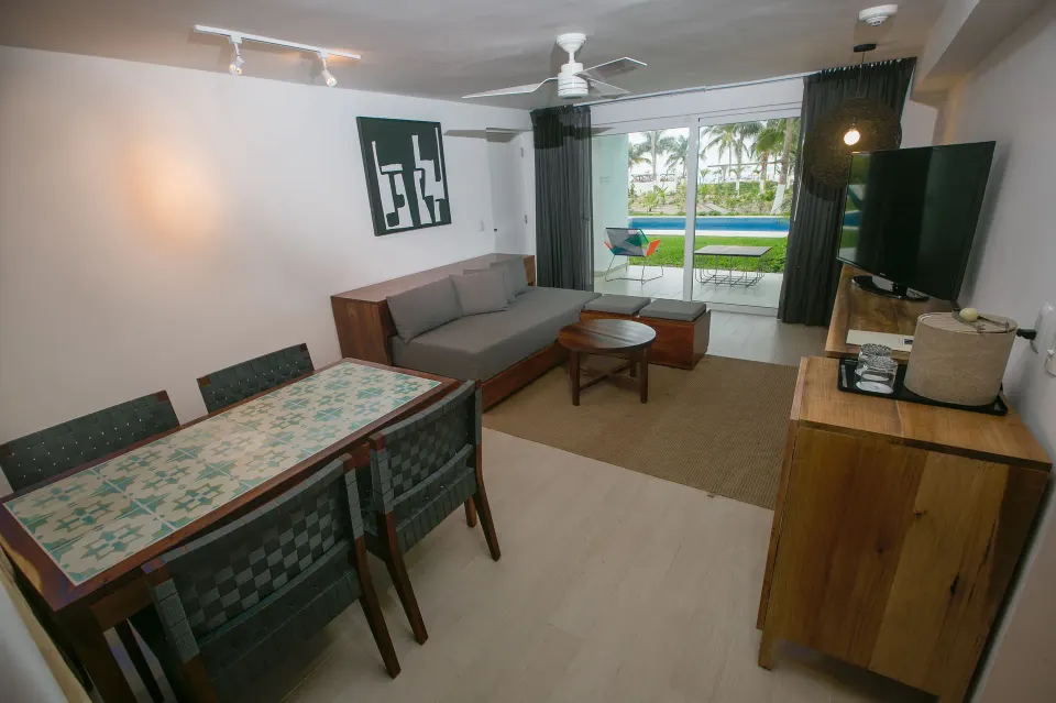 Living and dining area with private pool terrace at Fiesta Americana Cozumel.
