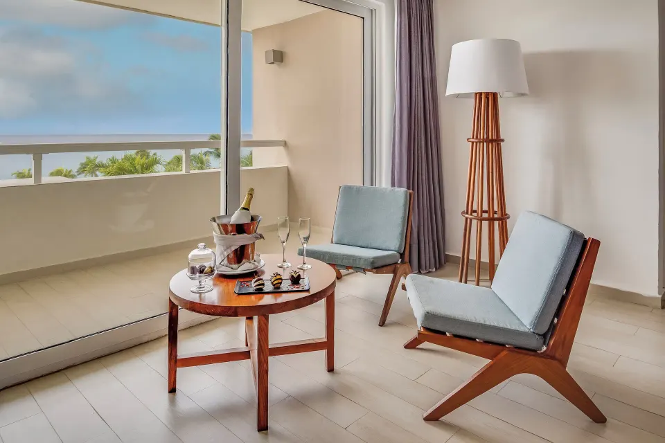 Honeymoon Suite lounge chairs by balcony doors at Fiesta Americana Cozumel.