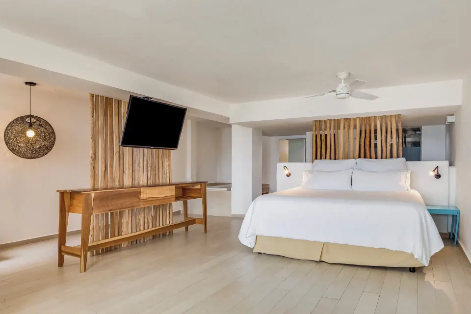 Honeymoon Suite king bed and TV at Fiesta Americana Cozumel.