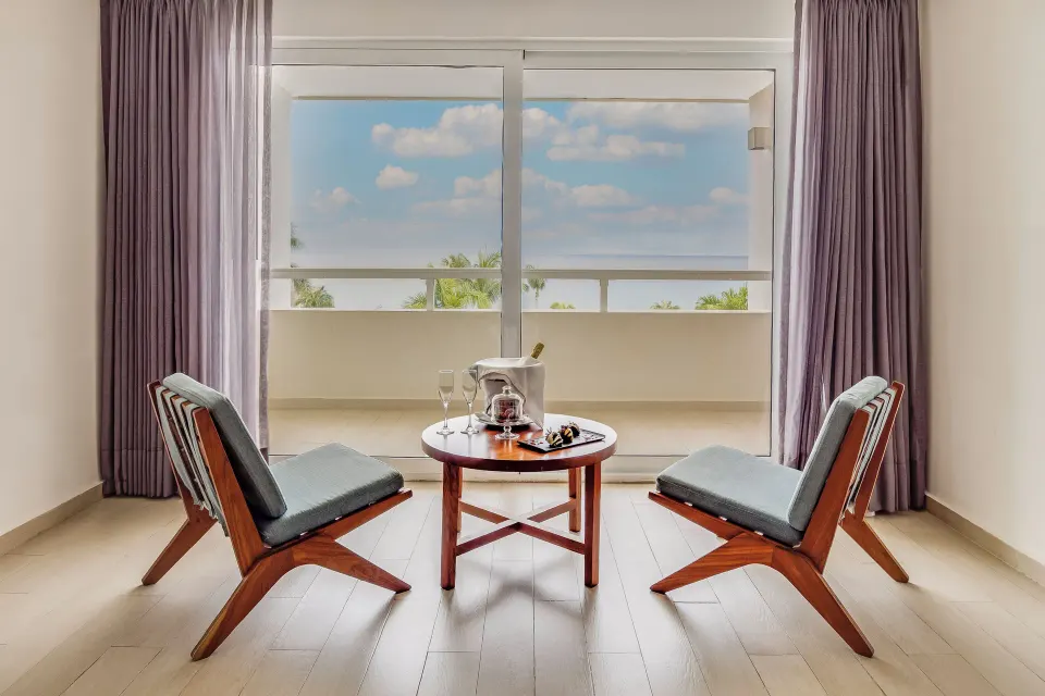 Honeymoon Suite sitting area with balcony view at Fiesta Americana Cozumel.