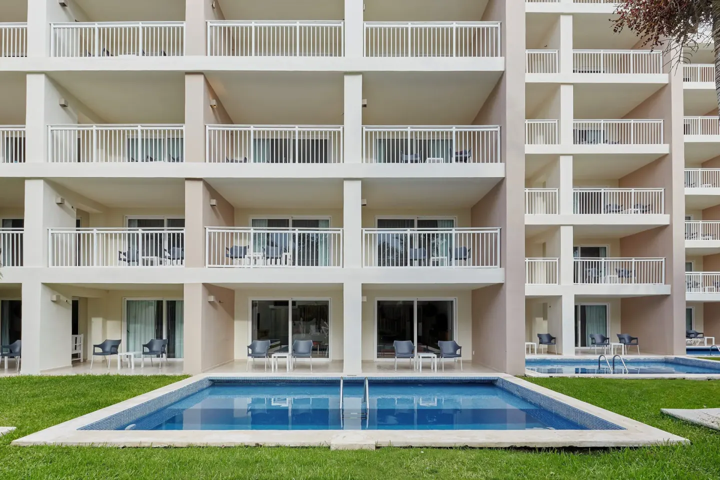 Ground-floor plunge pools and balconies outside suites at Fiesta Americana Cozumel.
