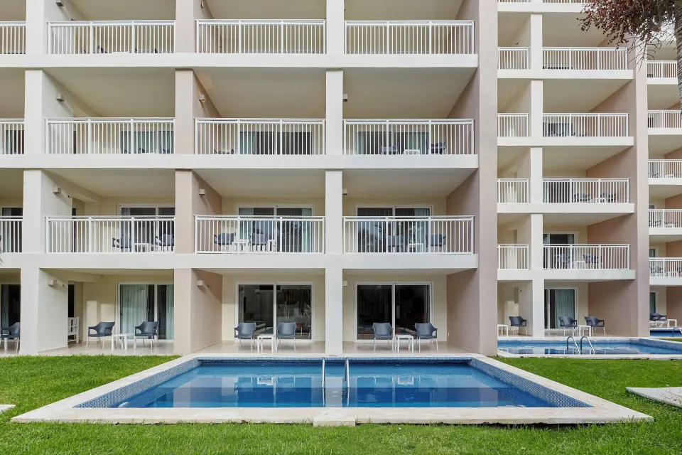 Ground-floor plunge pools and balconies outside suites at Fiesta Americana Cozumel.