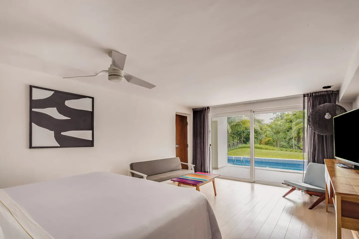 Master Suite king bed and seating area by a plunge pool at Fiesta Americana Cozumel.