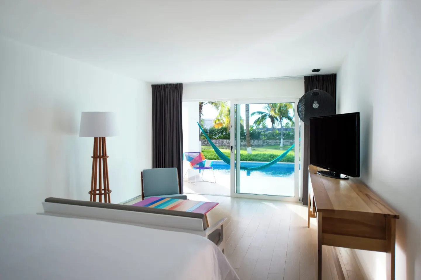 Master Suite king bed beside lounge and plunge pool terrace at Fiesta Americana Cozumel.