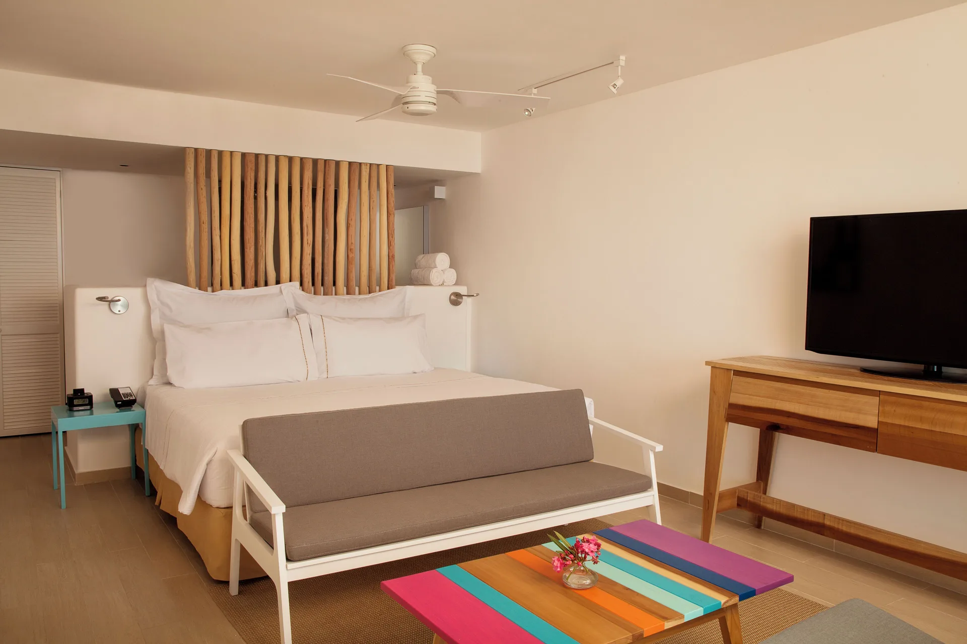 Presidential Suite at Fiesta Americana Cozumel with king bed, sofa, flat-screen TV, and elegant décor.