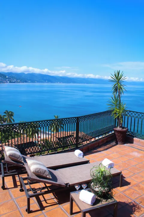 Terrace loungers overlooking the ocean and mountains at Fiesta Americana Puerto Vallarta & Spa.