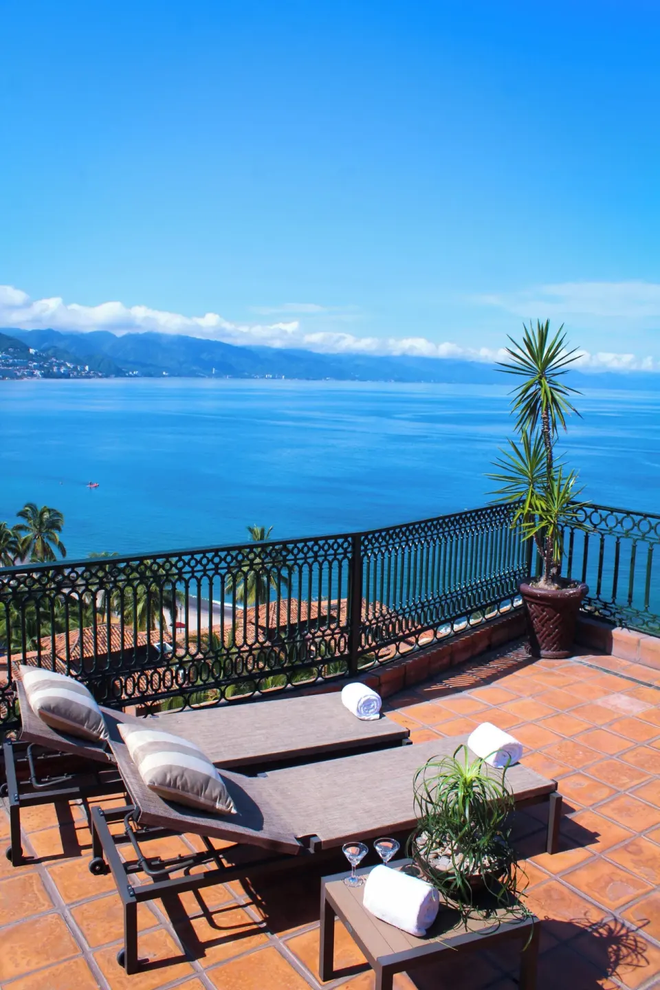 Terrace loungers overlooking the ocean and mountains at Fiesta Americana Puerto Vallarta & Spa.