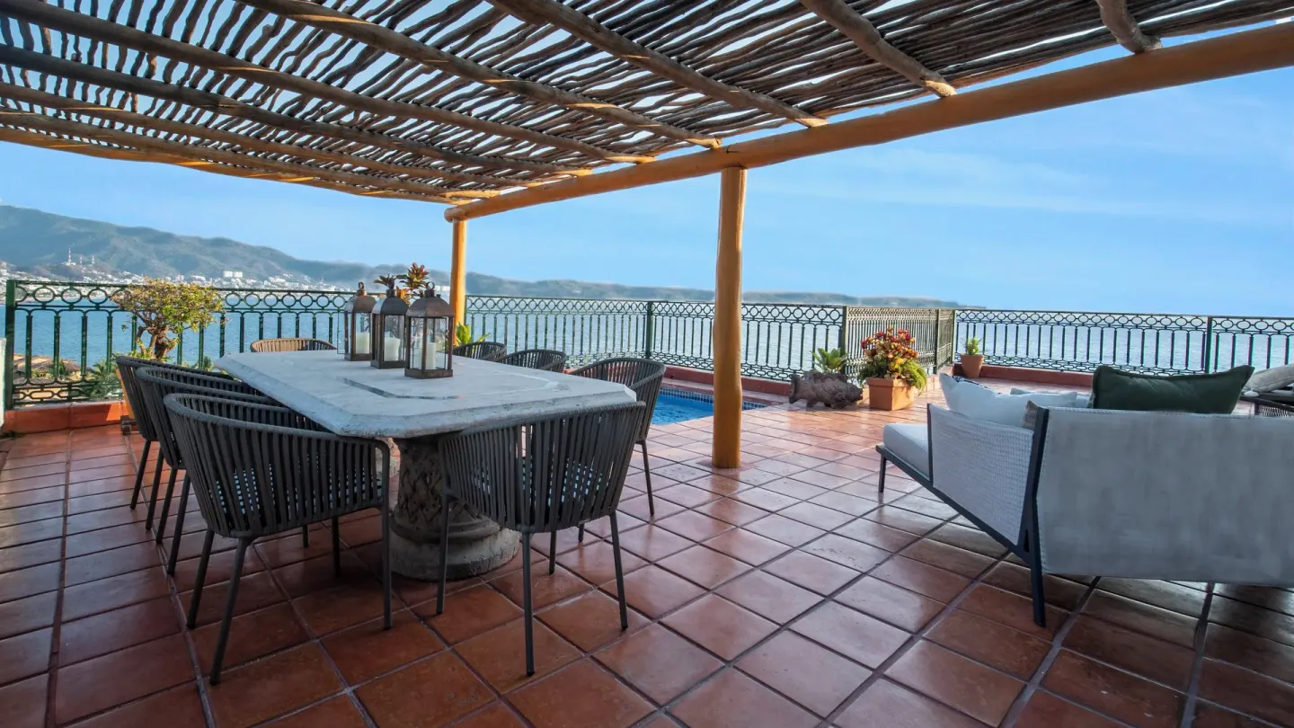 Shaded terrace dining table faces the bay at Fiesta Americana Puerto Vallarta & Spa.