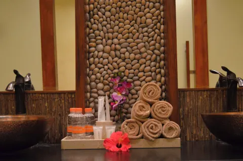 Spa sink counter with rolled towels and bath amenities at Fiesta Americana Puerto Vallarta & Spa.