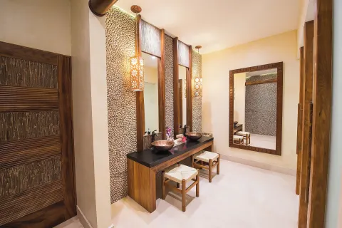 Spa vanity room with vessel sinks and stone accent walls at Fiesta Americana Puerto Vallarta & Spa.