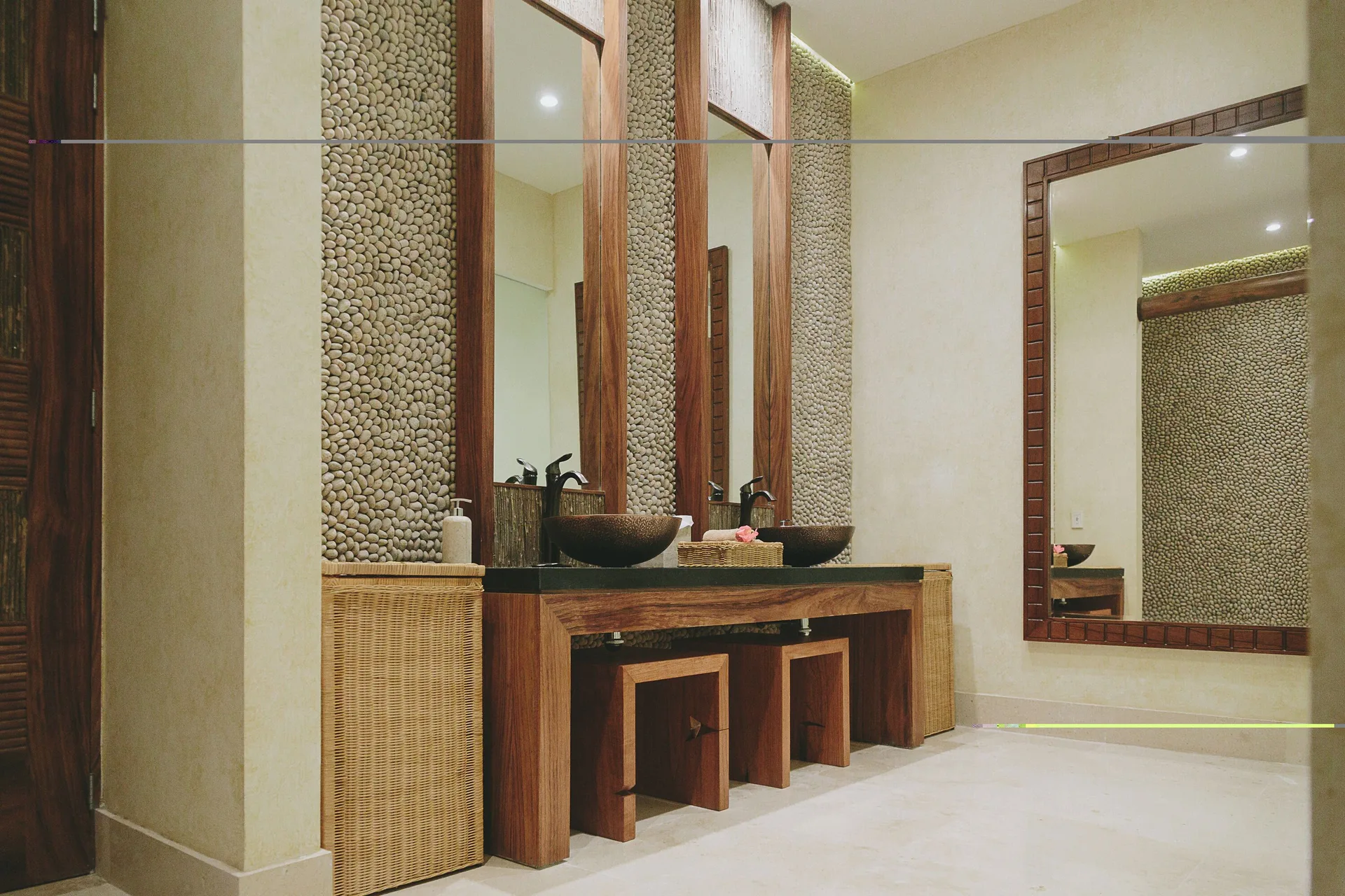 Spa washroom with double vessel sinks and pebble walls at Fiesta Americana Puerto Vallarta & Spa.