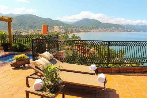 Terrace loungers overlook Banderas Bay and mountains at Fiesta Americana Puerto Vallarta & Spa.