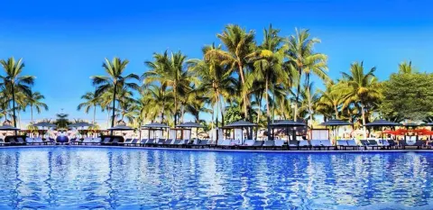 Wide pool view with cabanas and palm trees at Fiesta Americana Puerto Vallarta & Spa.
