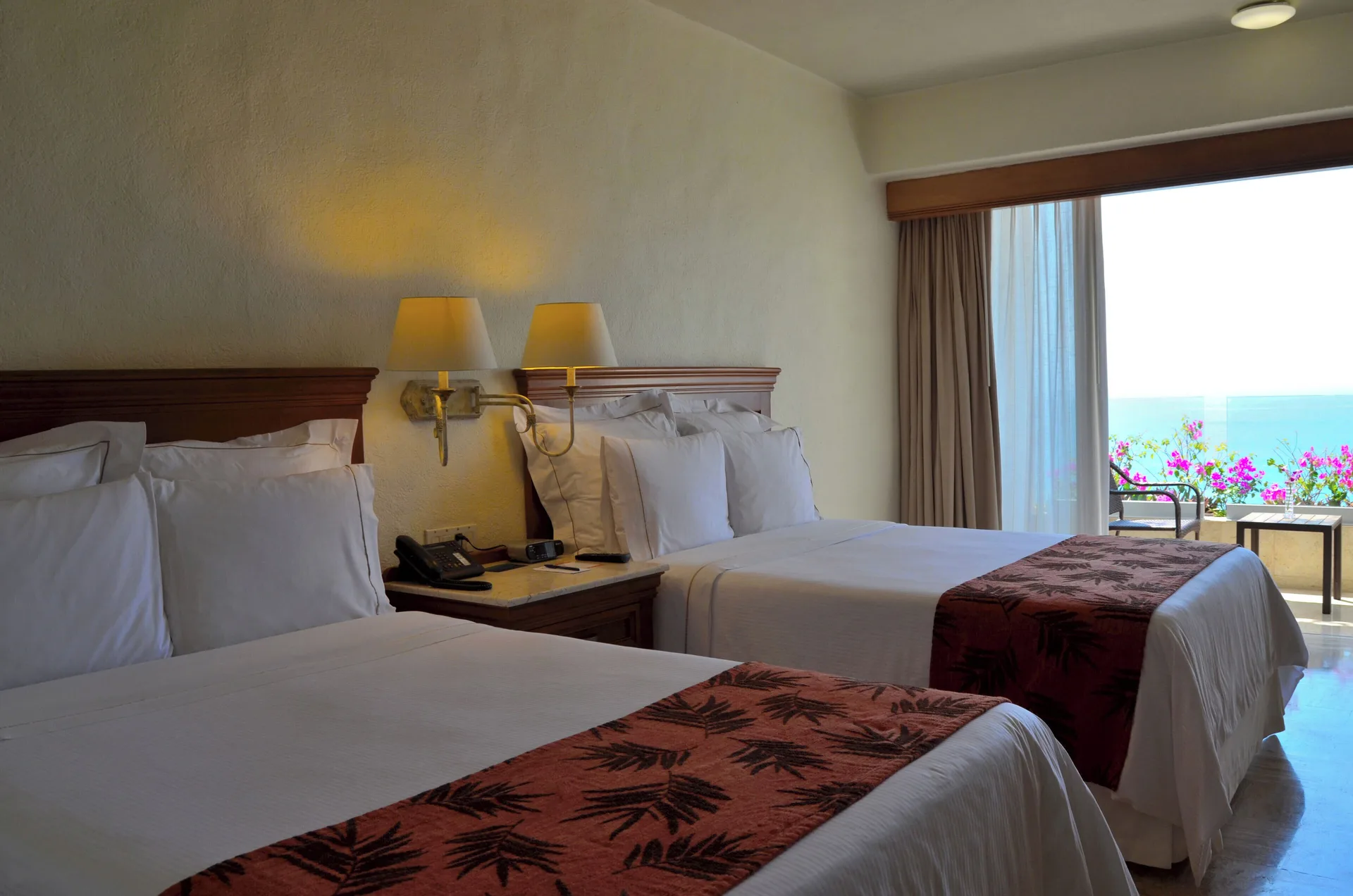 Family Room with two beds and ocean-facing balcony at Fiesta Americana Puerto Vallarta & Spa.