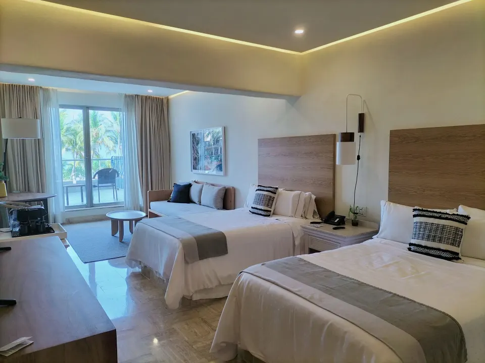 Updated Family Room with two beds, sofa, and balcony at Fiesta Americana Puerto Vallarta & Spa.