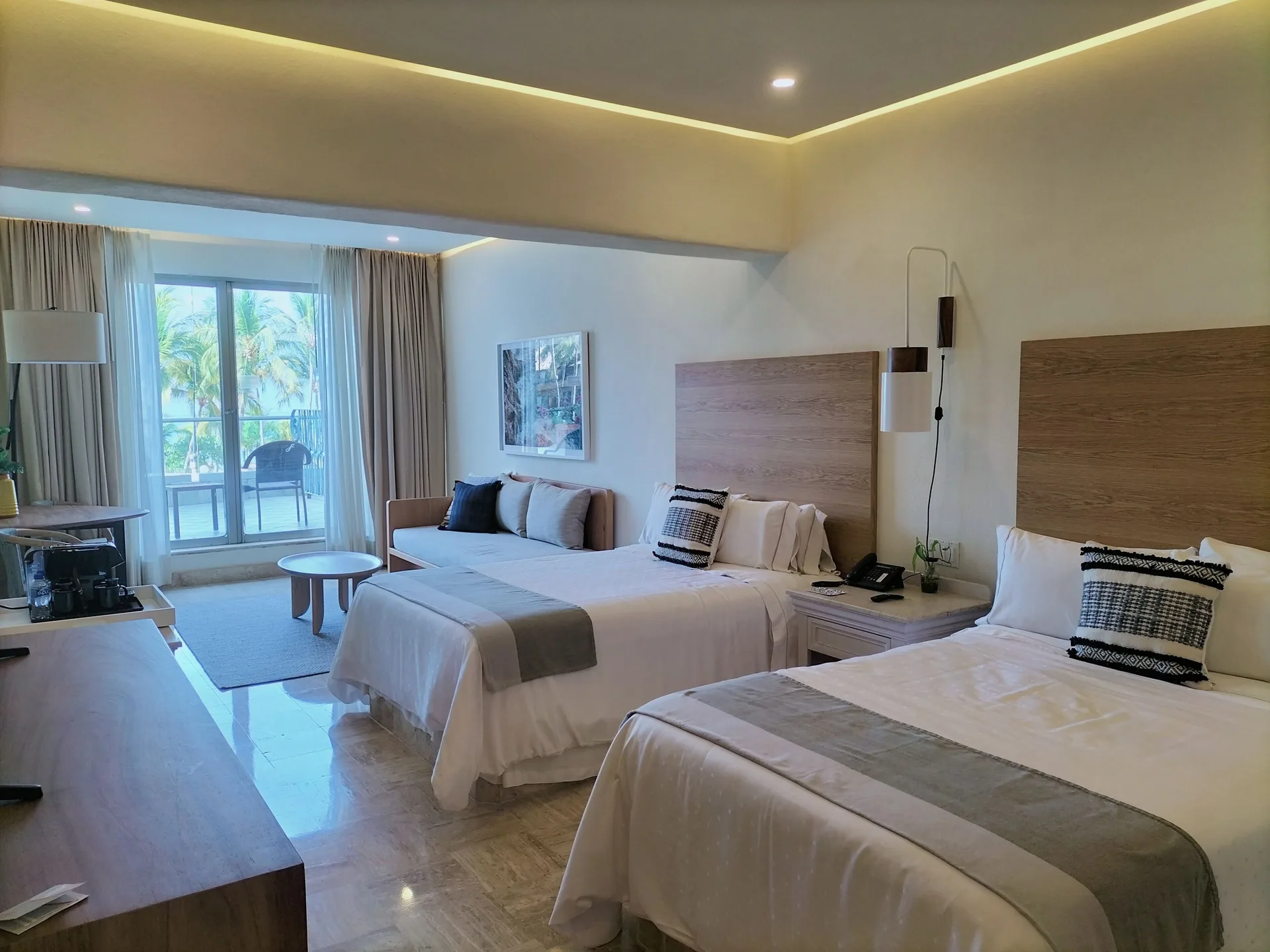 Updated Family Room with two beds, sofa, and balcony at Fiesta Americana Puerto Vallarta & Spa.