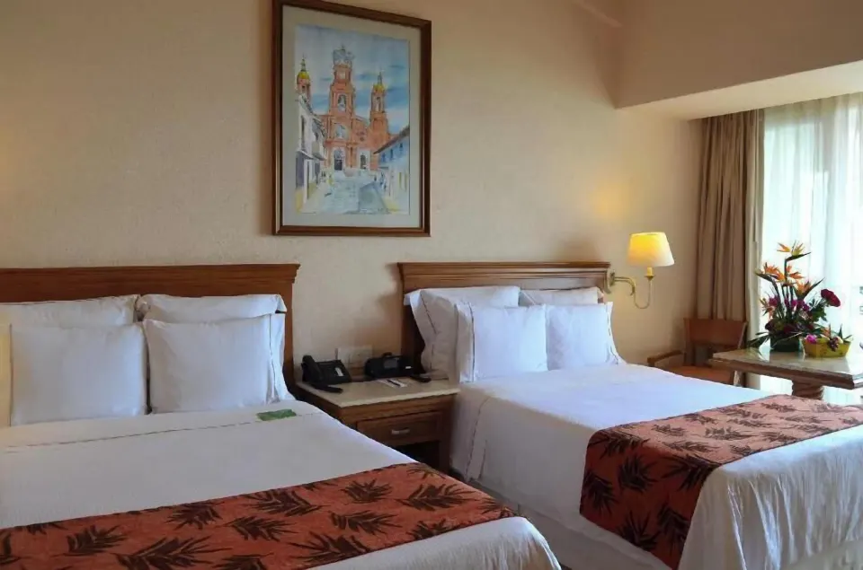 Fiesta Americana Puerto Vallarta & Spa with two beds and a flower arrangement at Fiesta Americana Puerto Vallarta & Spa.