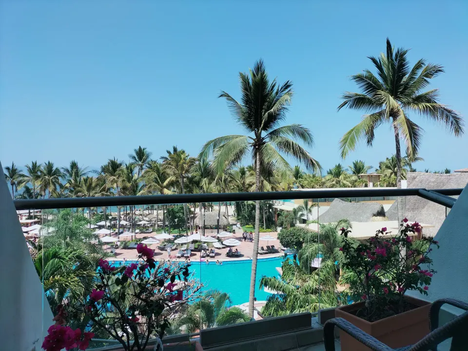 Partial ocean view from a Superior Room balcony at Fiesta Americana Puerto Vallarta & Spa over pool and palms.