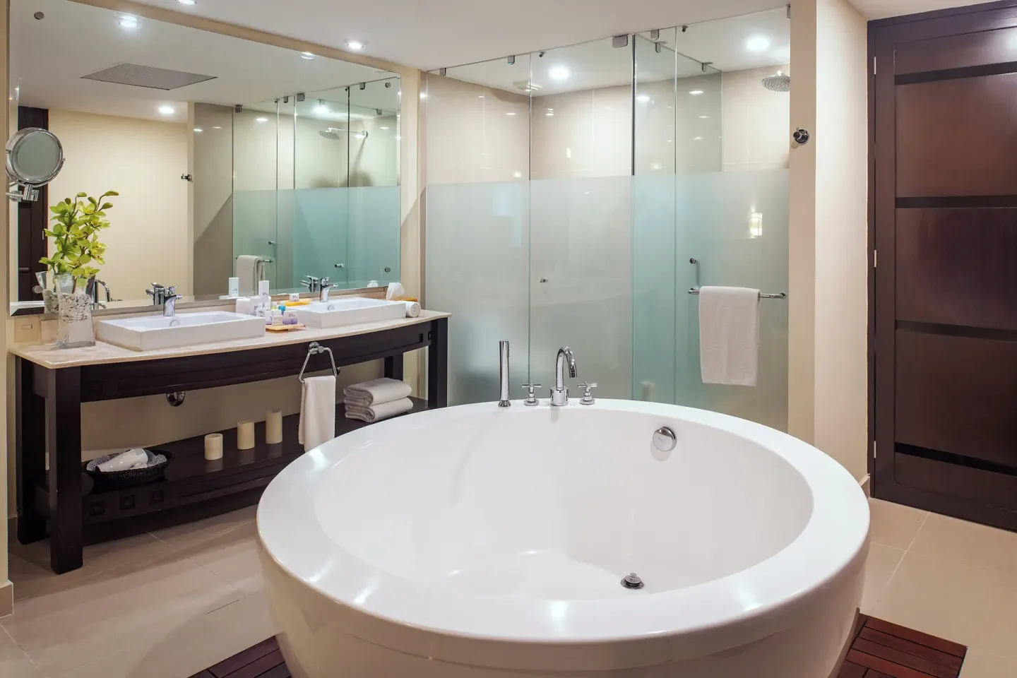 Bathroom with round soaking tub and glass shower at Fiesta Americana Riviera Nayarit Resort & Spa.