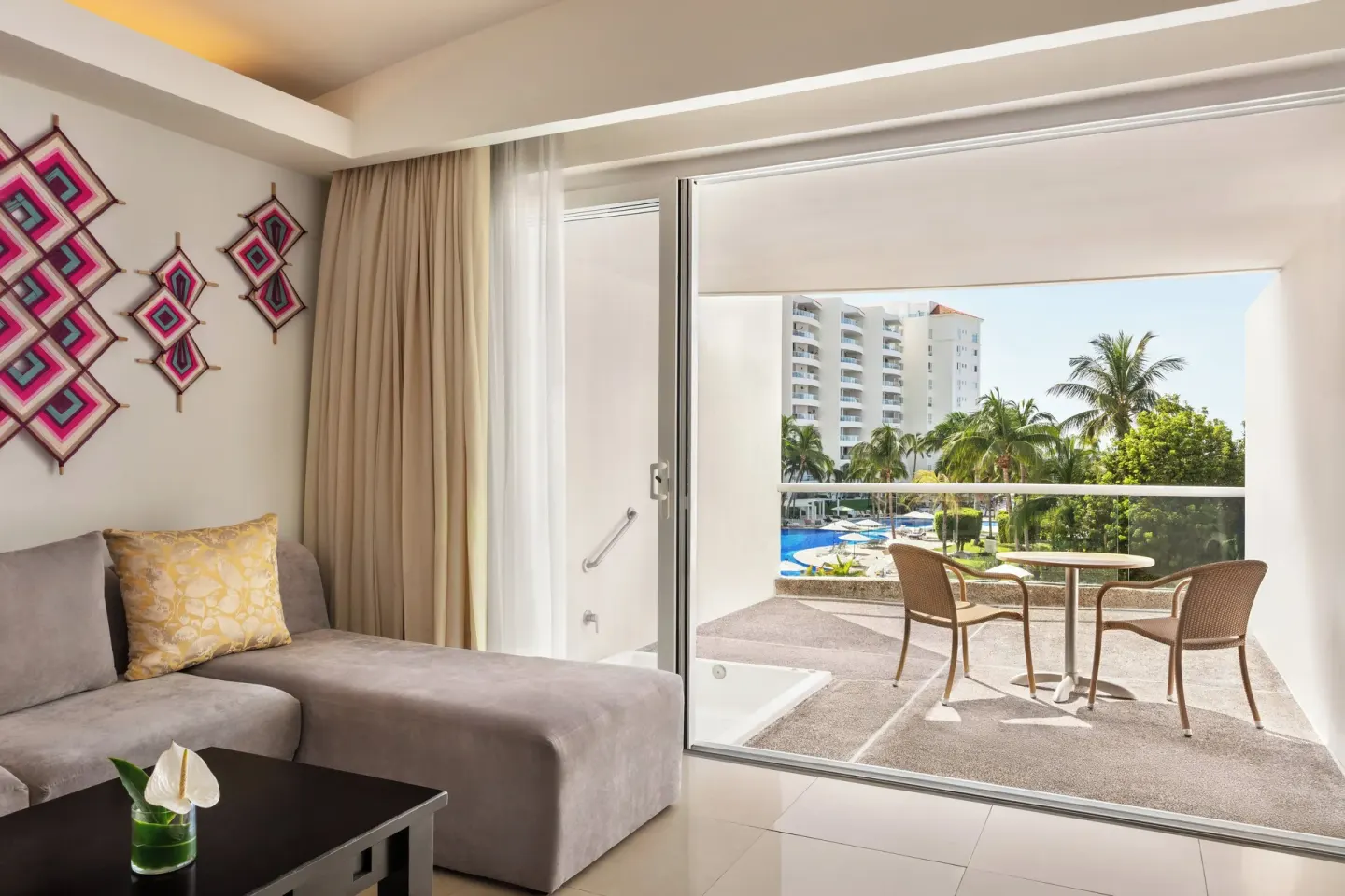 Guest room lounge area and balcony at Fiesta Americana Riviera Nayarit Resort & Spa.