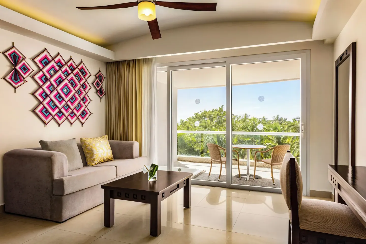 Guest room sitting area with balcony at Fiesta Americana Riviera Nayarit Resort & Spa.