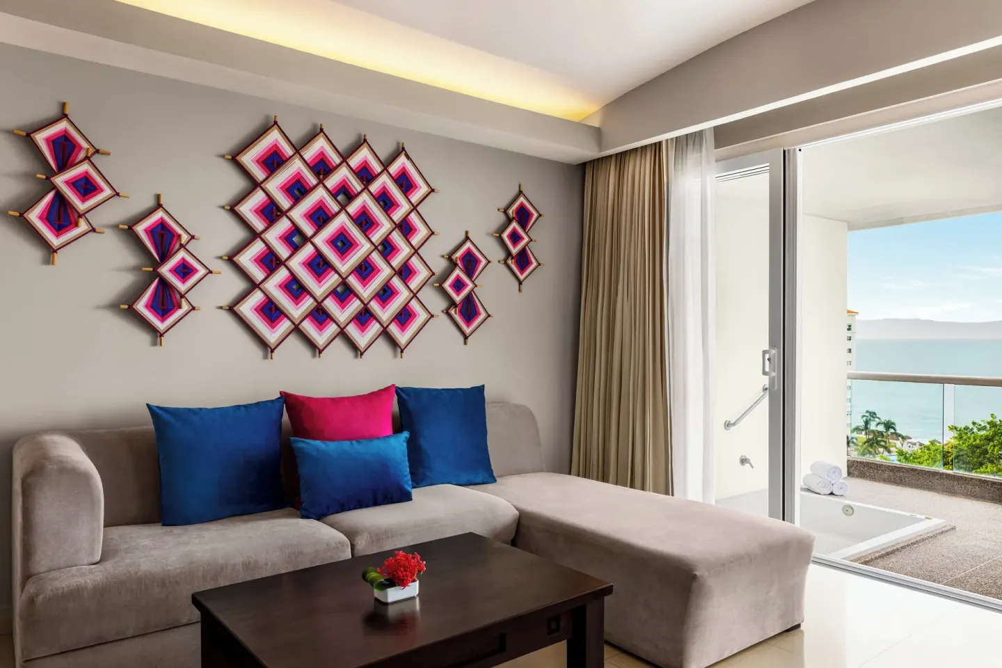 Sofa sitting area and balcony tub in a guest room at Fiesta Americana Riviera Nayarit Resort & Spa.