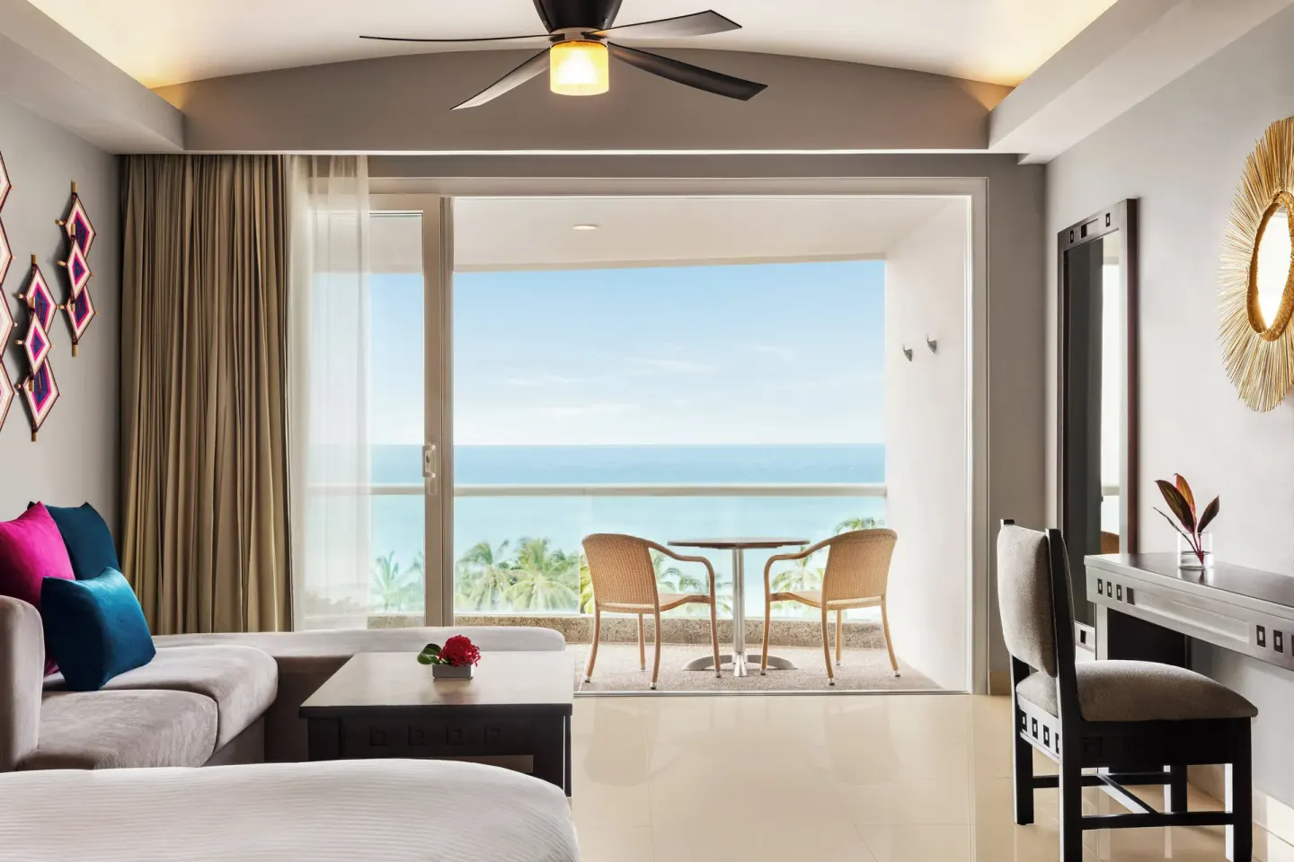 Ocean-view guest room with sofa, desk, and balcony at Fiesta Americana Riviera Nayarit Resort & Spa.