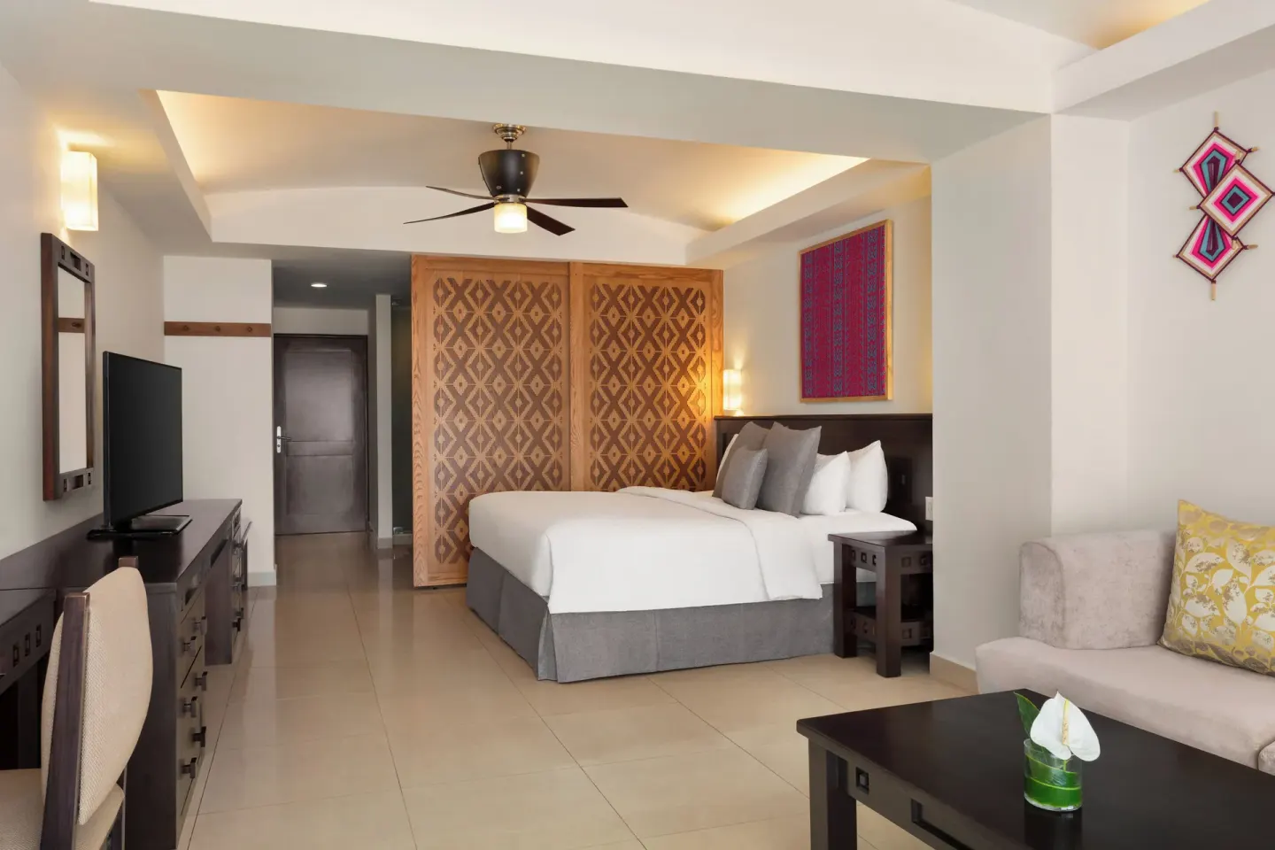Spacious king guest room with sofa and TV console at Fiesta Americana Riviera Nayarit Resort & Spa.