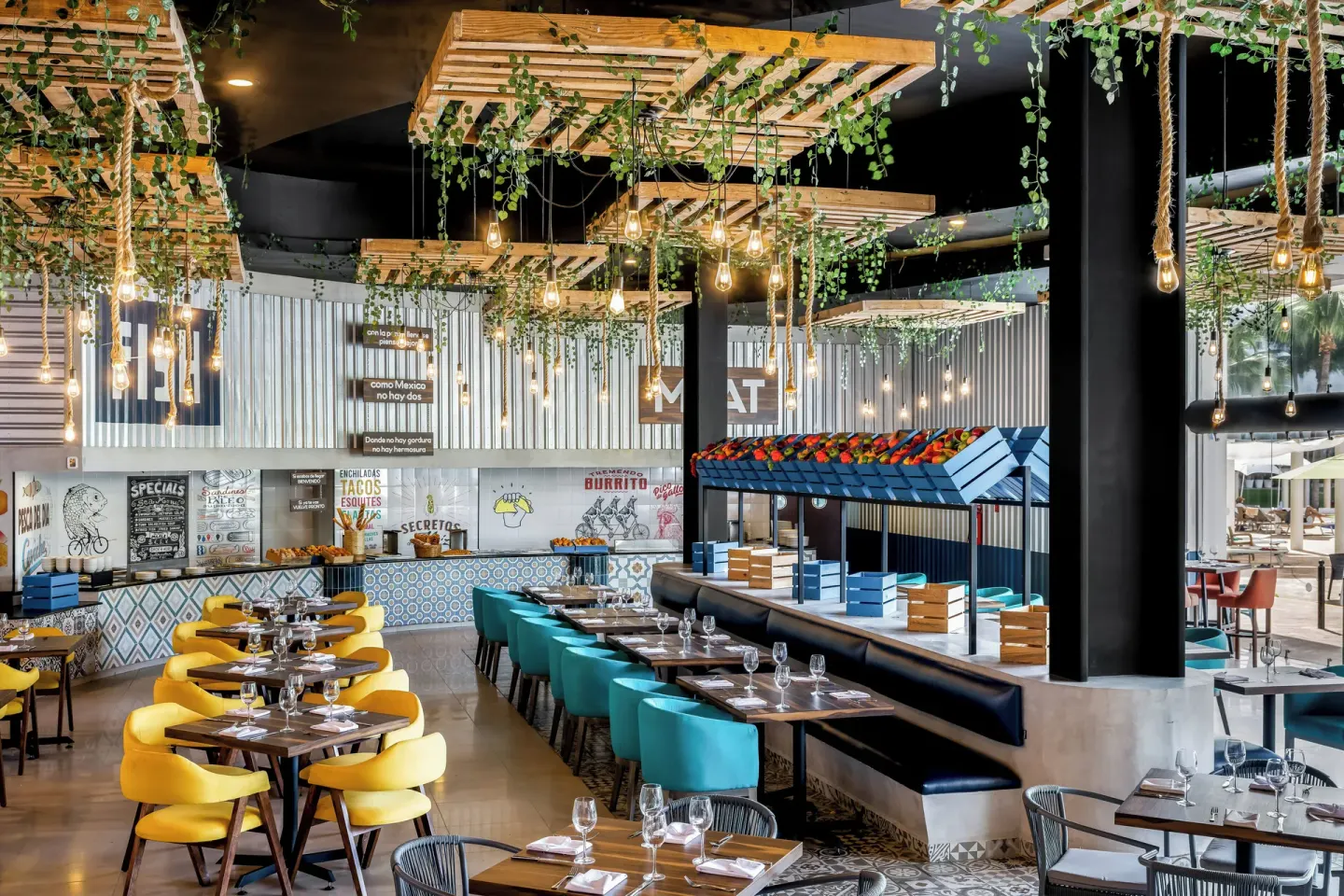 Colorful restaurant with hanging plants at Fiesta Americana Riviera Nayarit Resort & Spa.