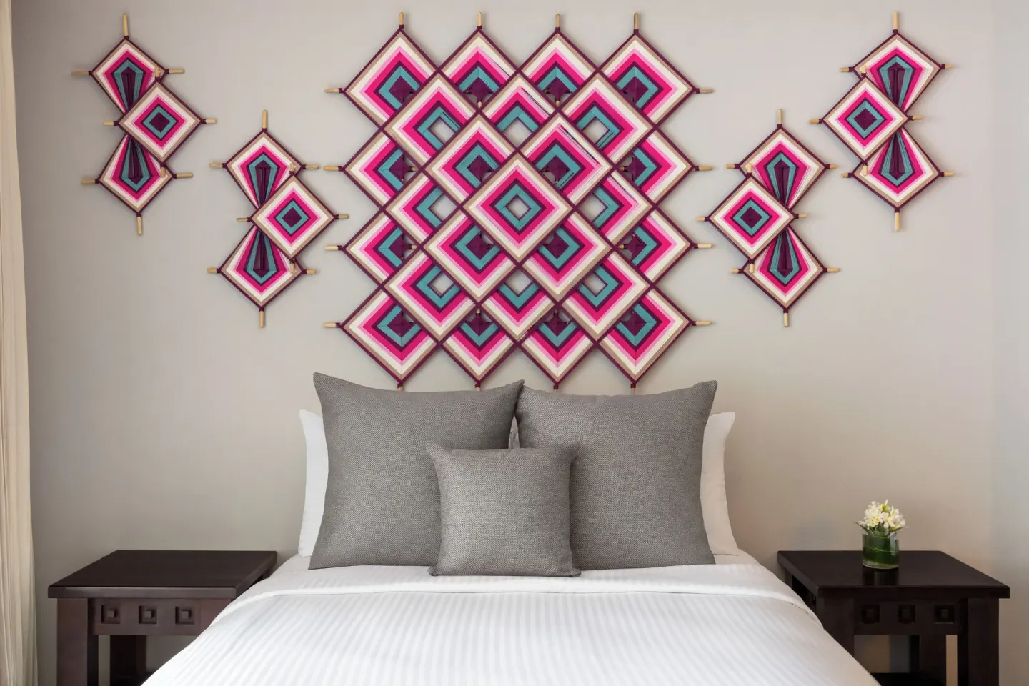 Junior Suite bed with colorful woven wall art at Fiesta Americana Riviera Nayarit Resort & Spa.