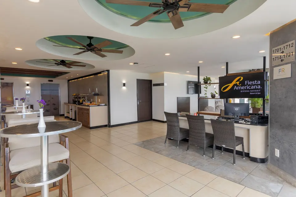 Club lounge seating, buffet counter and reception desk at Fiesta Americana Riviera Nayarit Resort & Spa.