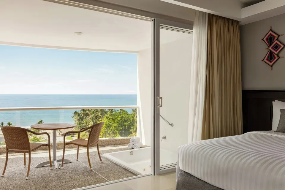 Junior Suite Ocean View bed and balcony at Fiesta Americana Riviera Nayarit Resort & Spa.