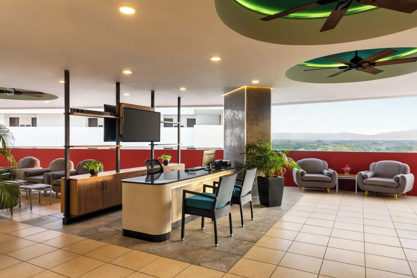 Open concierge lounge area at Fiesta Americana Riviera Nayarit Resort & Spa with seating and distant hills.