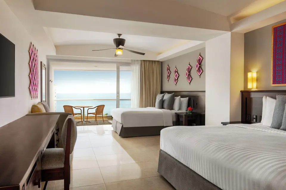 Junior Suite Ocean View at Fiesta Americana Riviera Nayarit Resort & Spa with two beds and balcony seating.