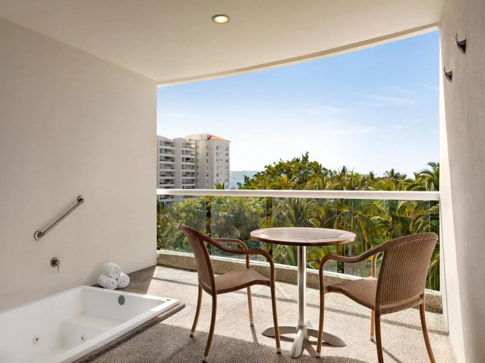 Junior Suite Tropical View balcony seating and tub at Fiesta Americana Riviera Nayarit Resort & Spa.