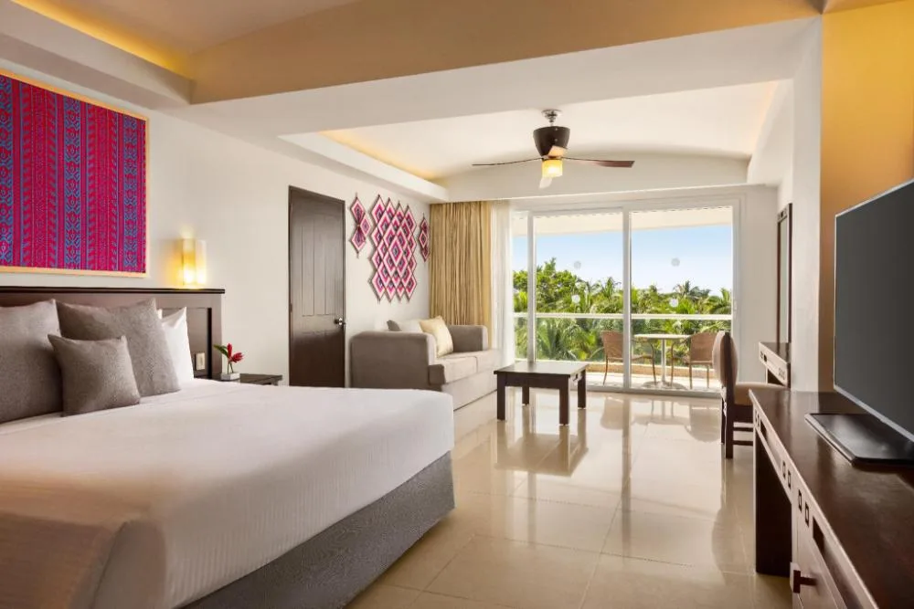Junior Suite Tropical View with king bed and sofa at Fiesta Americana Riviera Nayarit Resort & Spa.