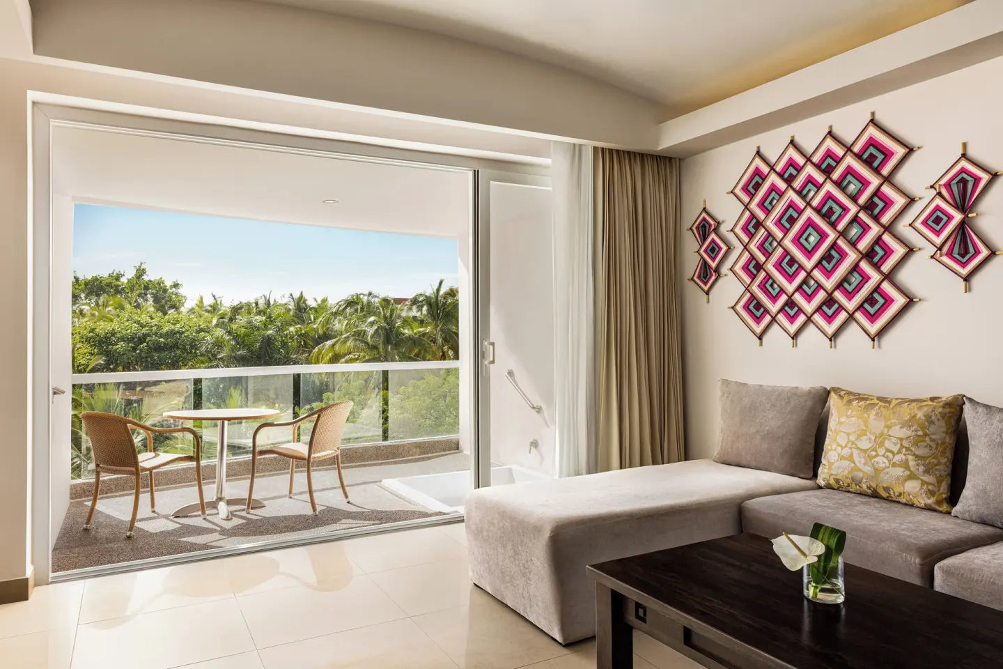 Junior Suite lounge and balcony with palm view at Fiesta Americana Riviera Nayarit Resort & Spa.
