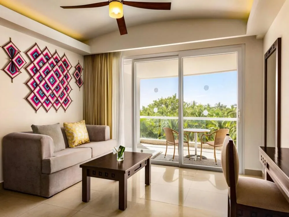 Junior Suite Tropical View sitting area and balcony at Fiesta Americana Riviera Nayarit Resort & Spa.
