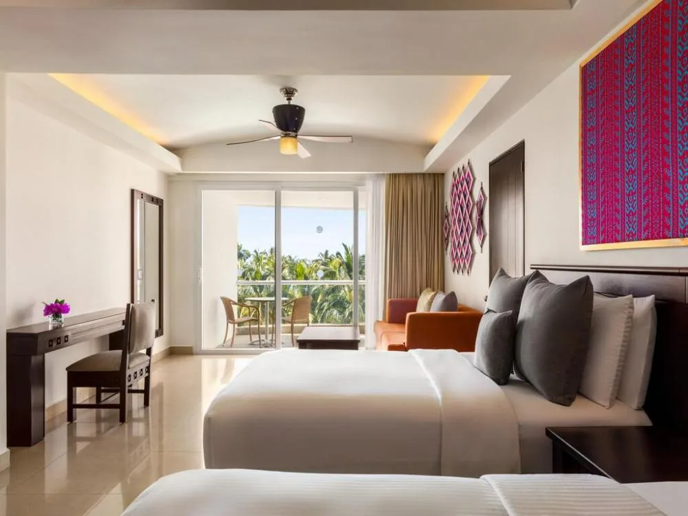 Junior Suite Tropical View with beds and balcony at Fiesta Americana Riviera Nayarit Resort & Spa.