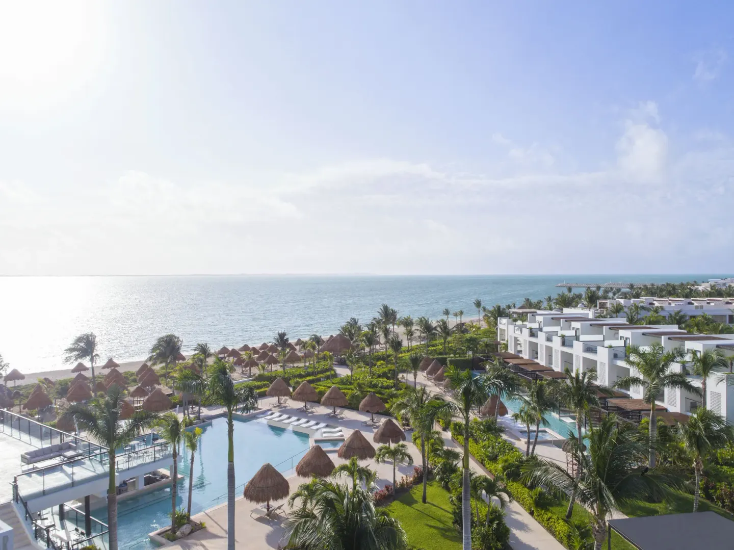 Aerial view of pools, palms, beachfront and resort buildings at Finest Playa Mujeres.
