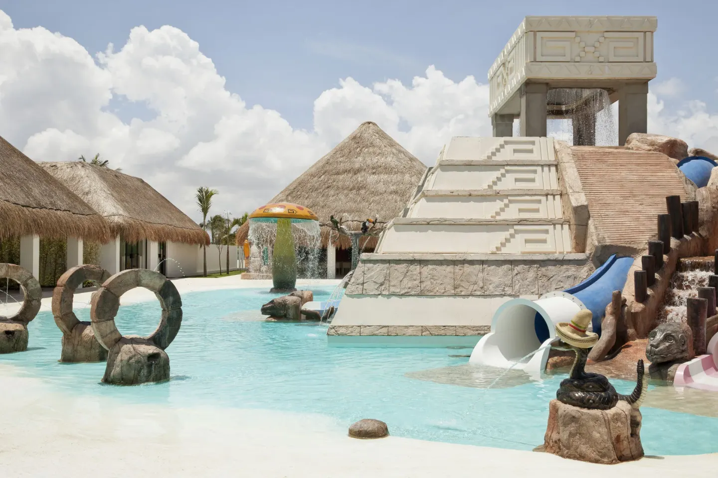 Children's pool with temple-style water feature and slides at Finest Playa Mujeres.