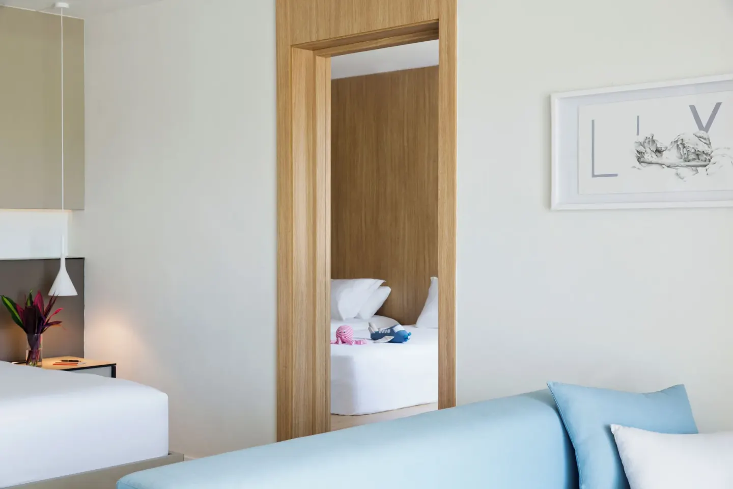 Guest room with two white beds and blue daybed at Finest Playa Mujeres.