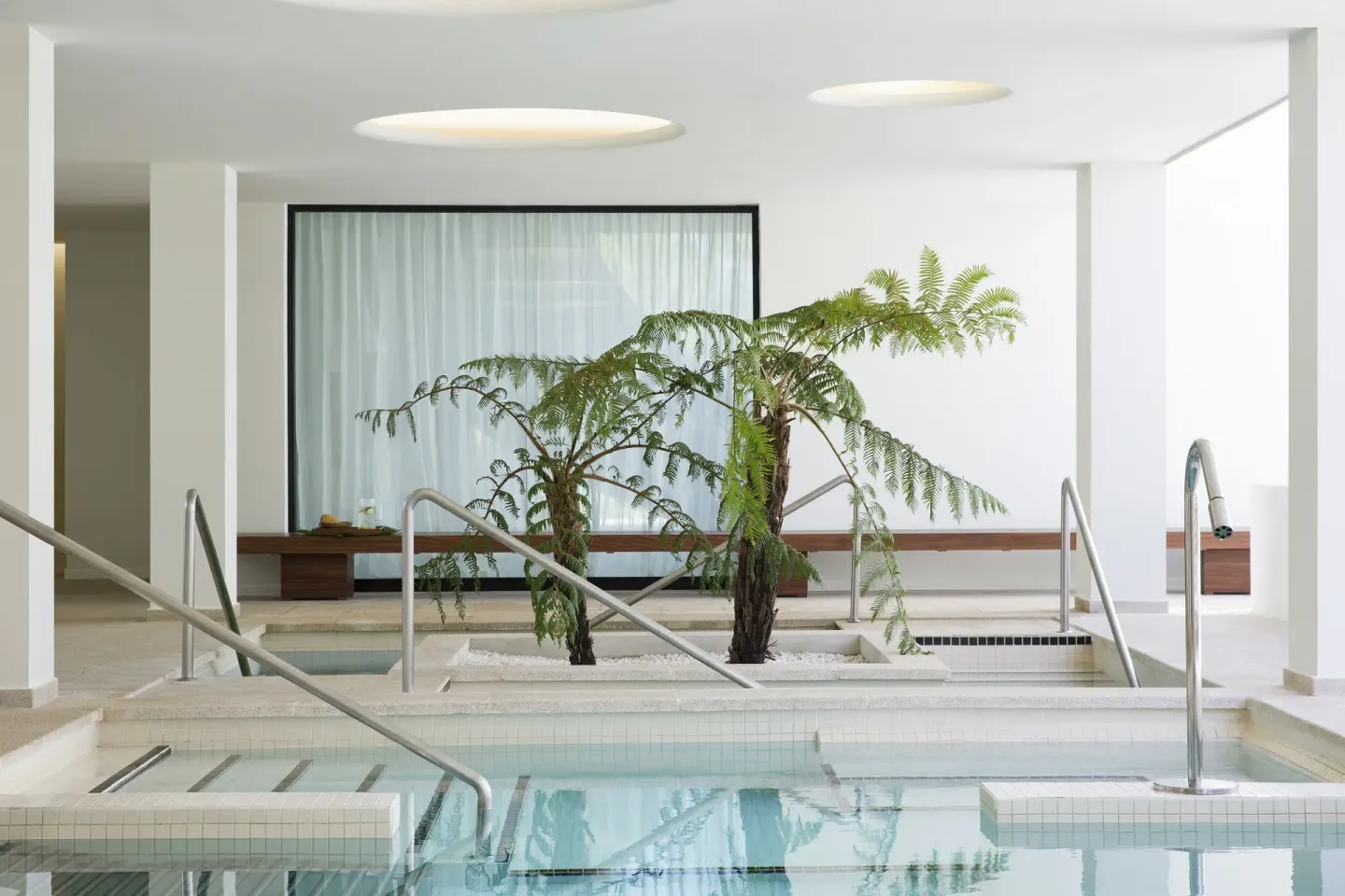 Spa hydrotherapy pool with handrails and indoor greenery at Finest Playa Mujeres.
