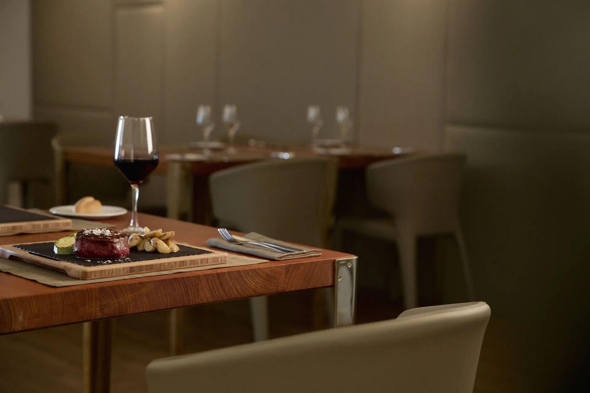 Steak entrée with red wine served in a dining room at Finest Playa Mujeres.