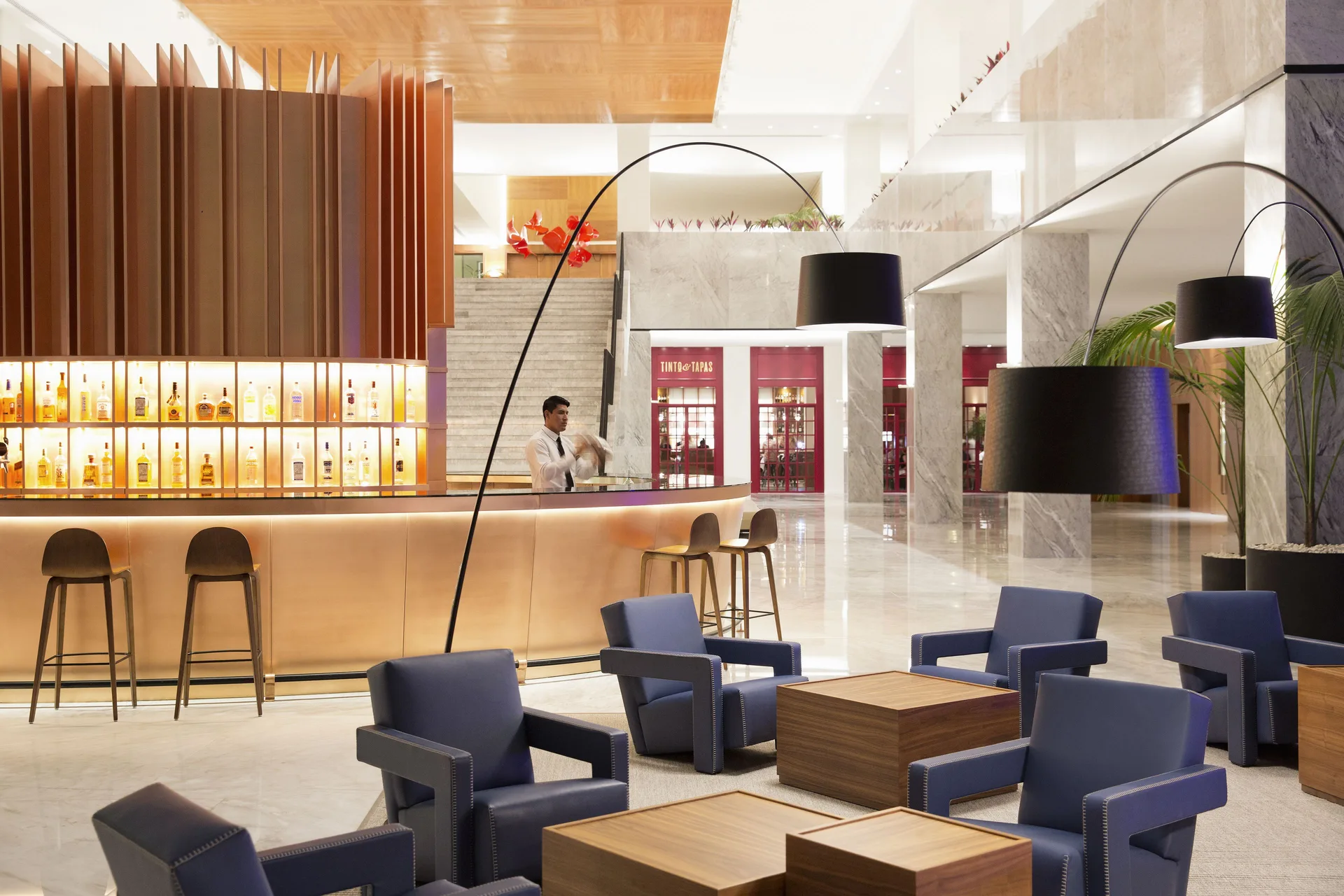 Lobby bar with lounge seating and Tinto & Tapas entrance beyond at Finest Playa Mujeres.