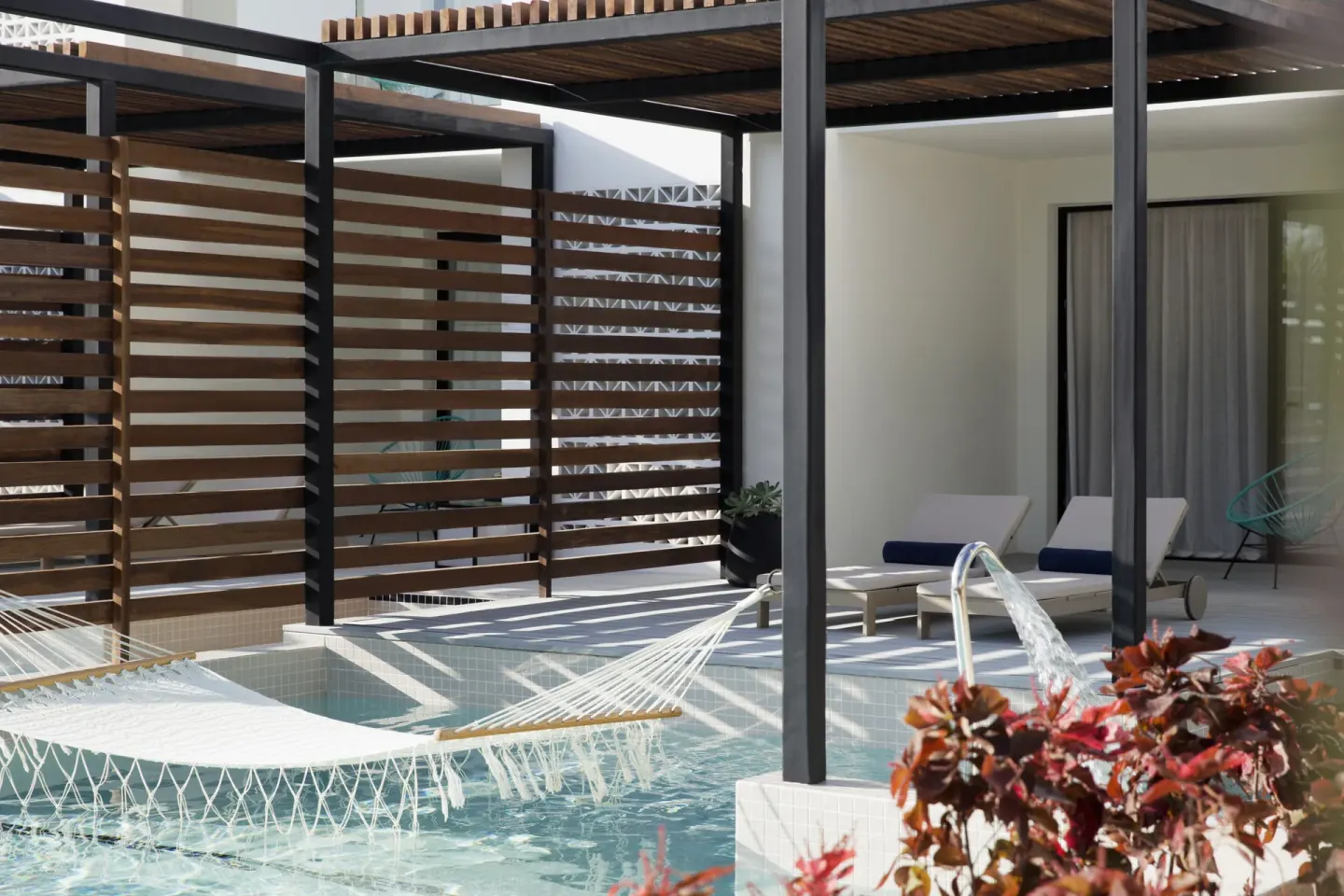 Excellence Club Junior Swim-up Suite terrace with pool hammock at Finest Playa Mujeres.
