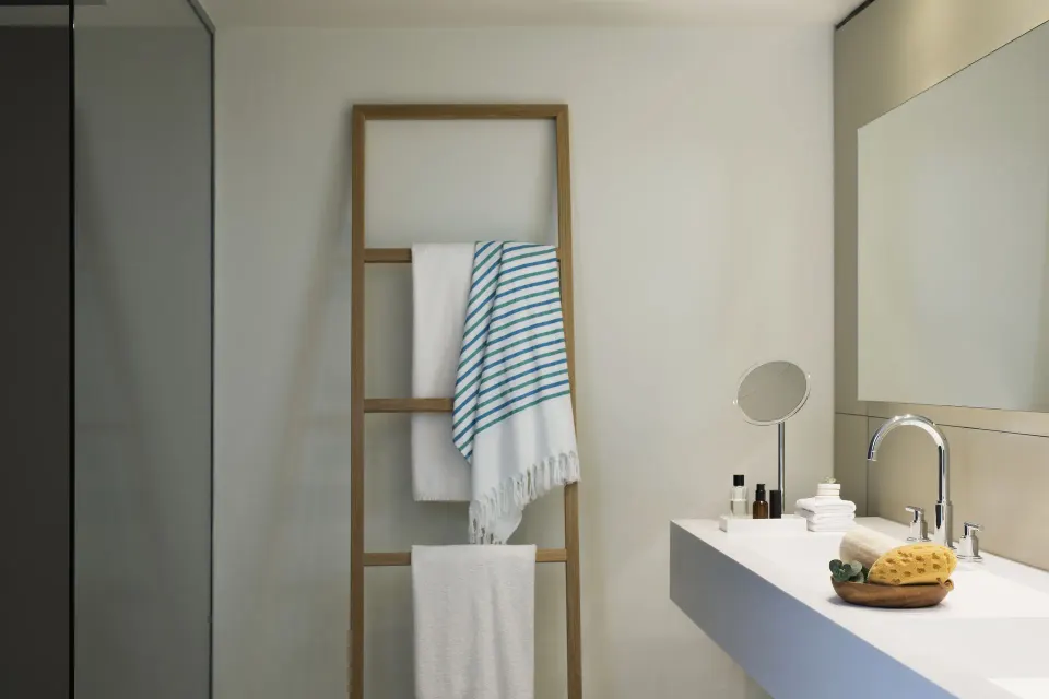 Junior Suite Spa or Pool View bathroom vanity and towel ladder at Finest Playa Mujeres.
